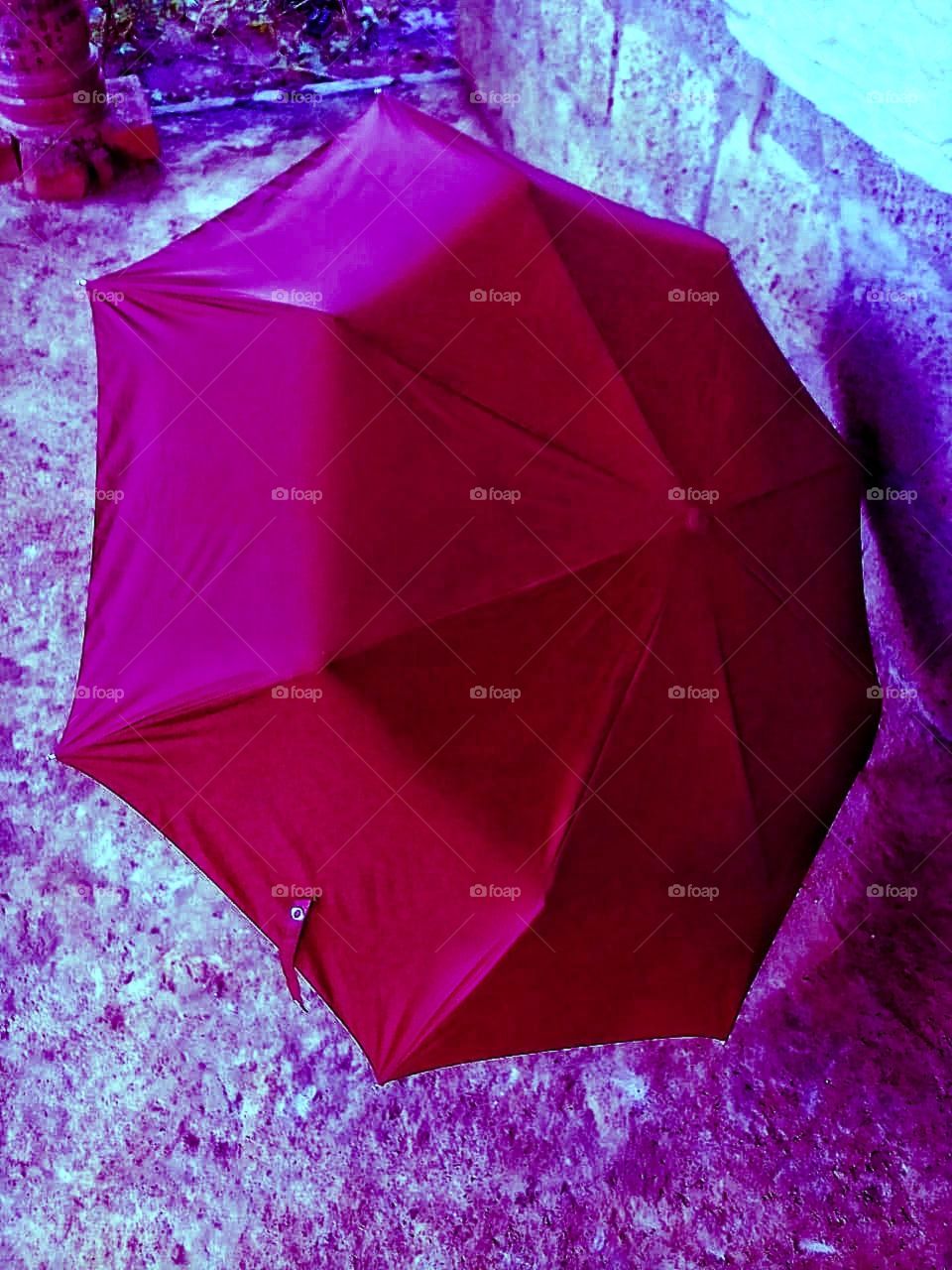 Red colour  umbrella out side of the house