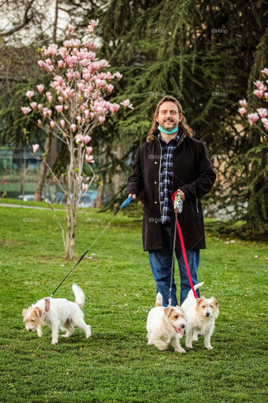 Portrait of a man in nature with puppies