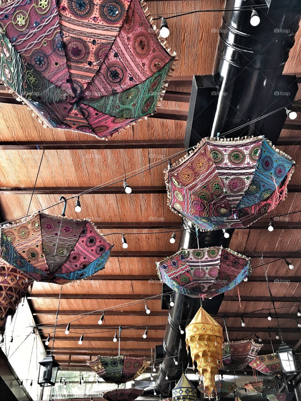 Embroidered umbrellas and lanterns as ceiling decorations in India