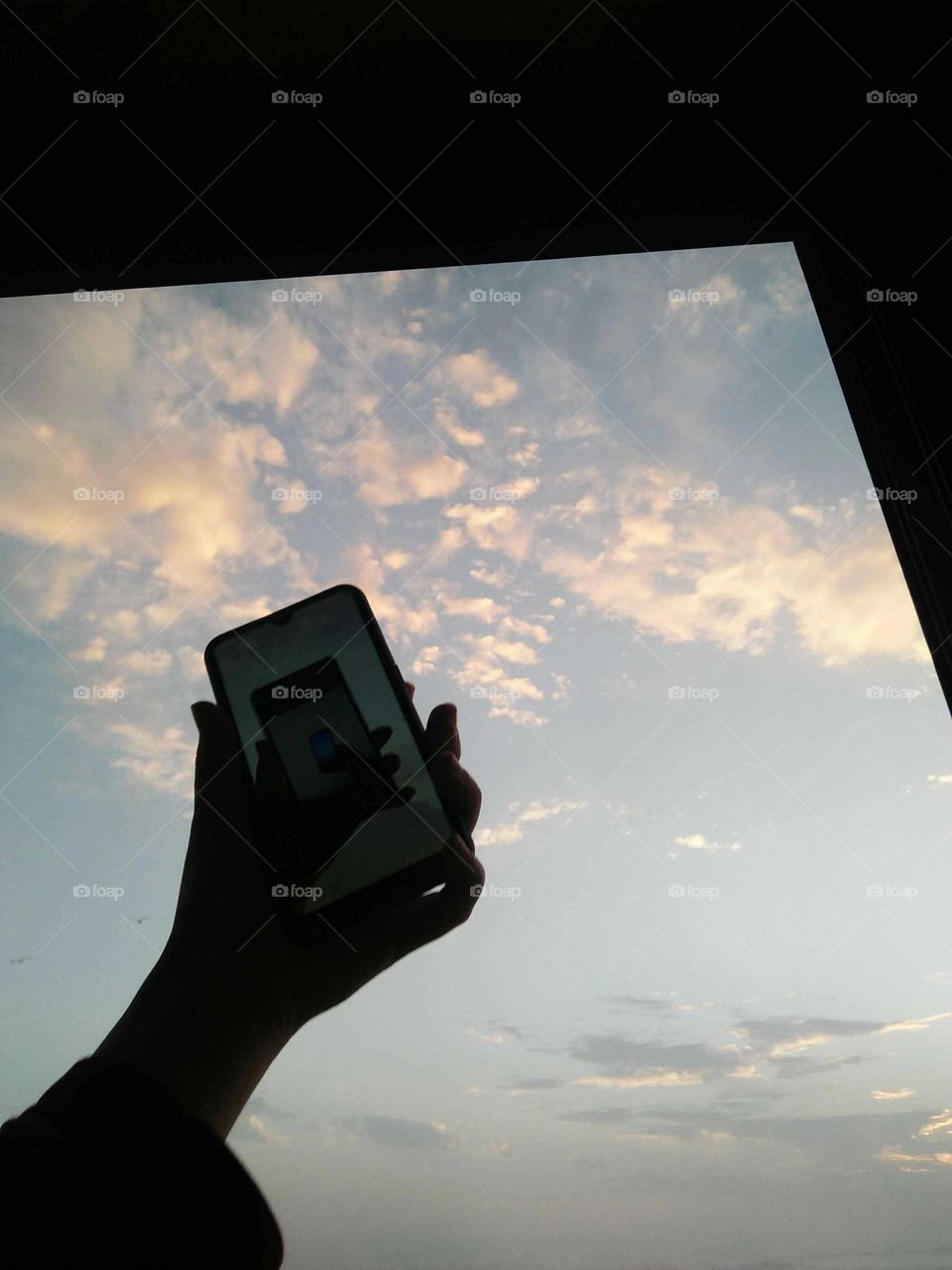 My smartphone and beautiful view to sea from the window.