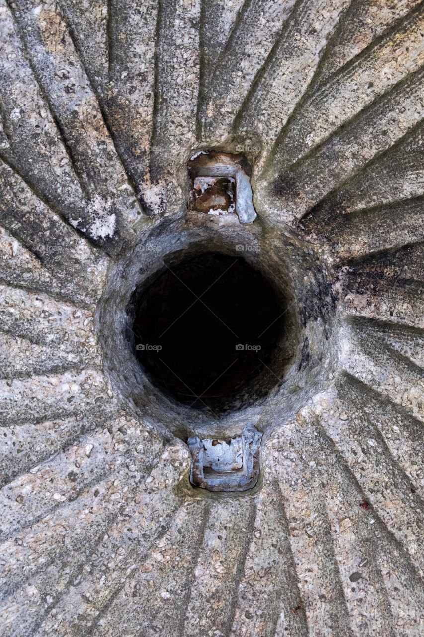 Center of a stone grinding wheel used to grind corn and wheat many years ago in an old gristmill. Historic Yates  County Park in Raleigh North Carolina. 