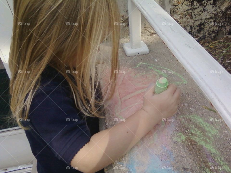 Girl drawing with chalk