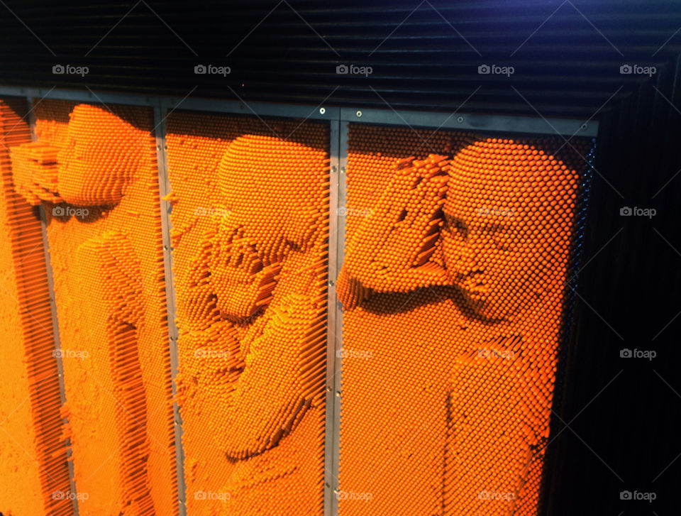 Three dimensional portrait created by impressing pegs in a screen