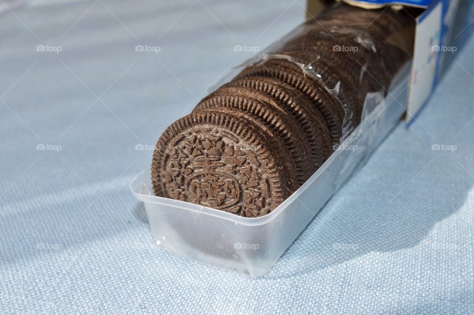 Oreo cookies in a plastic sleeve on a blue background