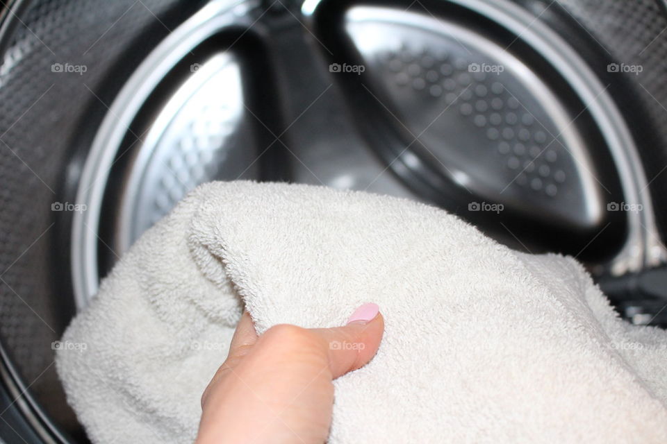 Putting laundry in the washer