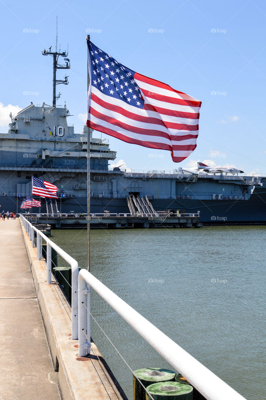 Line of American flags leading to the U.S.S. Yorktown