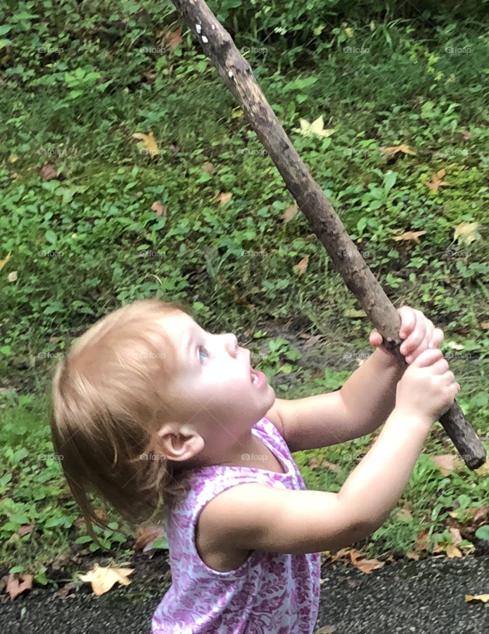 Little girl afraid of a stick