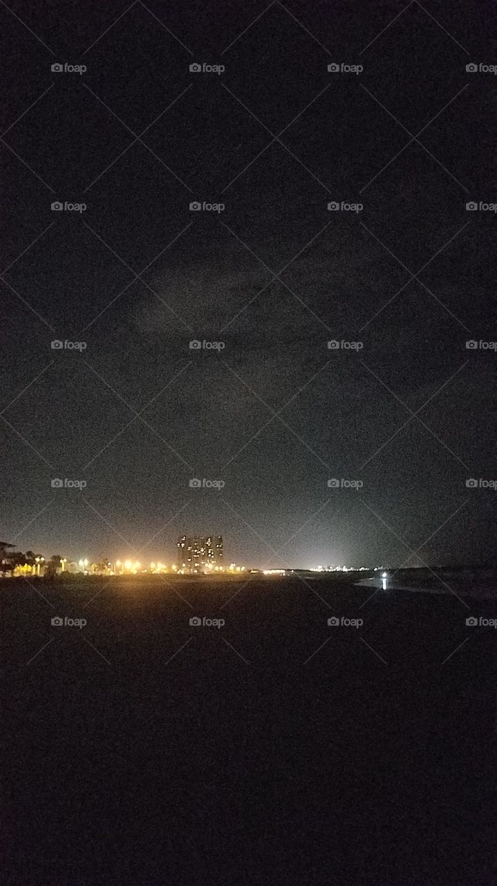 standing on the beach at night looking north towards the Strand