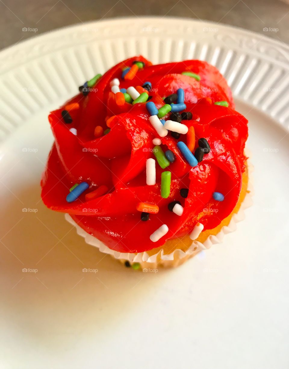 Red cupcake with rainbow sprinkles 