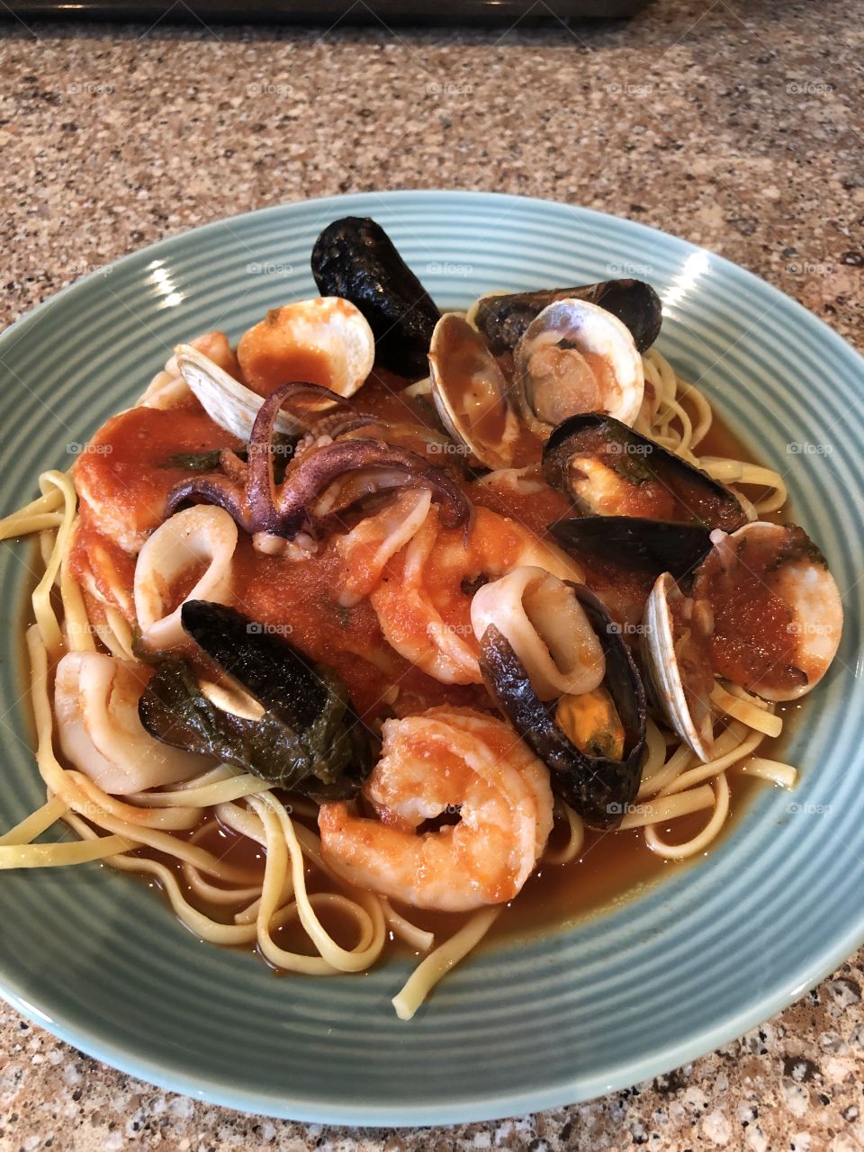 A delicious, homemade seafood pasta with shrimp, muscles, clams, and calamari. 