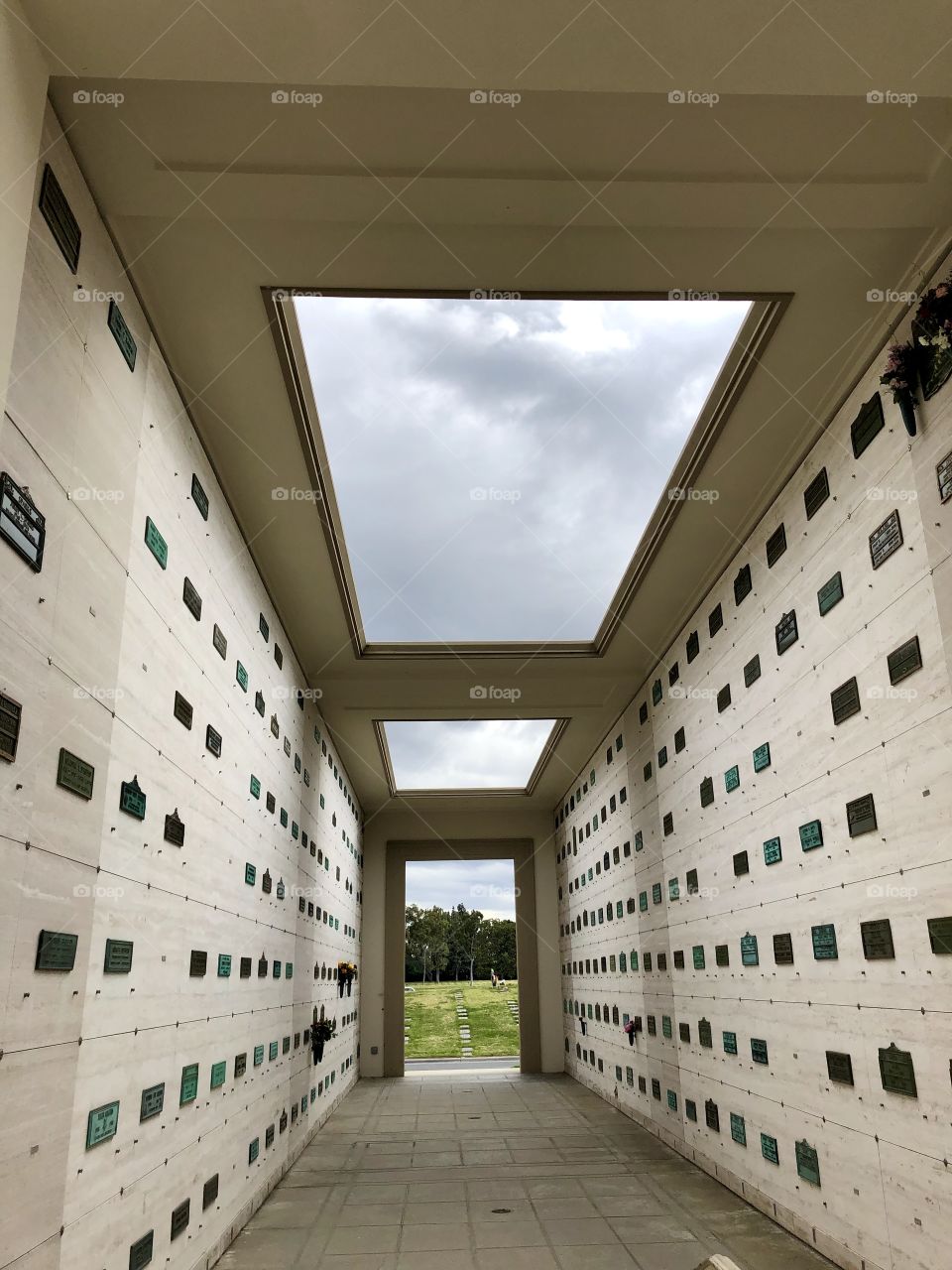 Memorial walls with sky view of clouds.