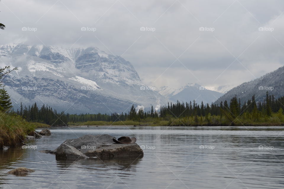 Cowboy hat on a rock in remote Canadian Rocky Mountain wilderness 