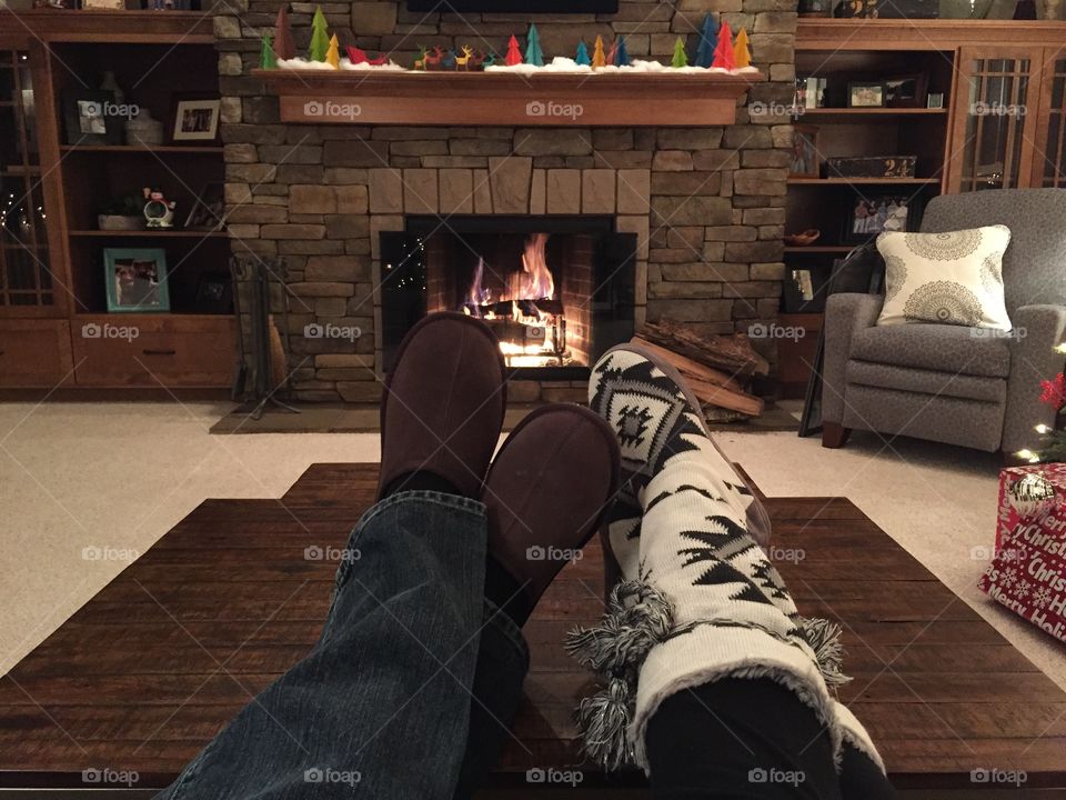 Feet in front of the fireplace 