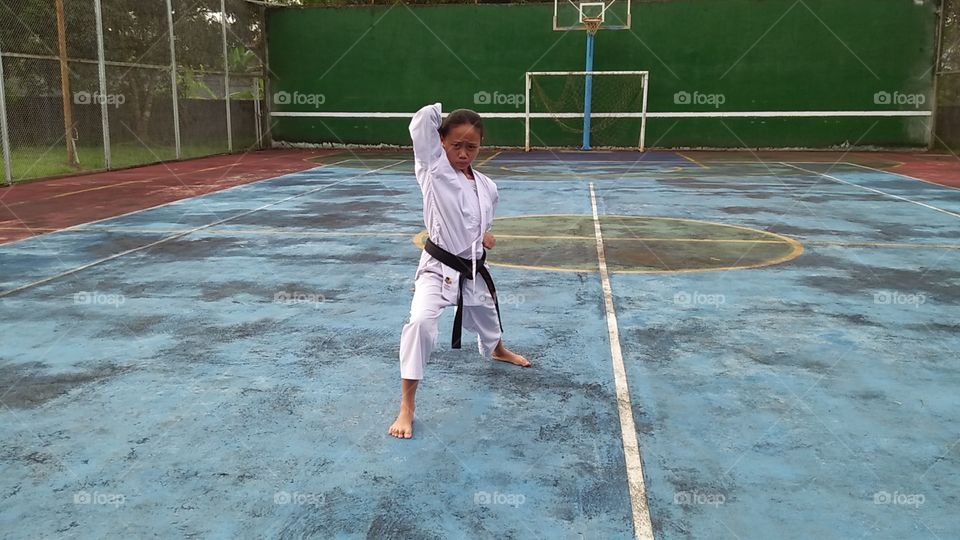 asian black belt girl practicing karate