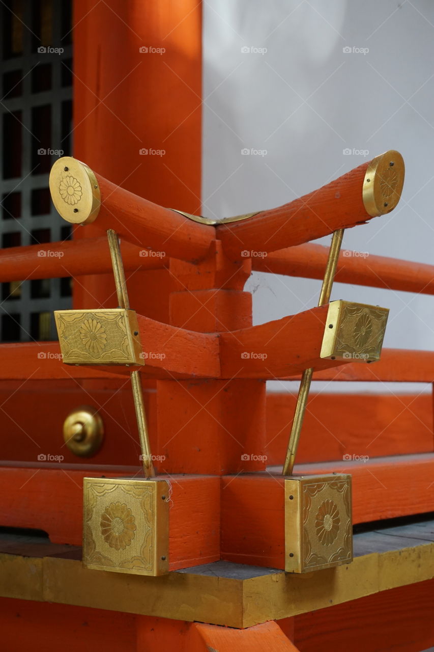 Brass decorative ends to a balustrade at a shrine 