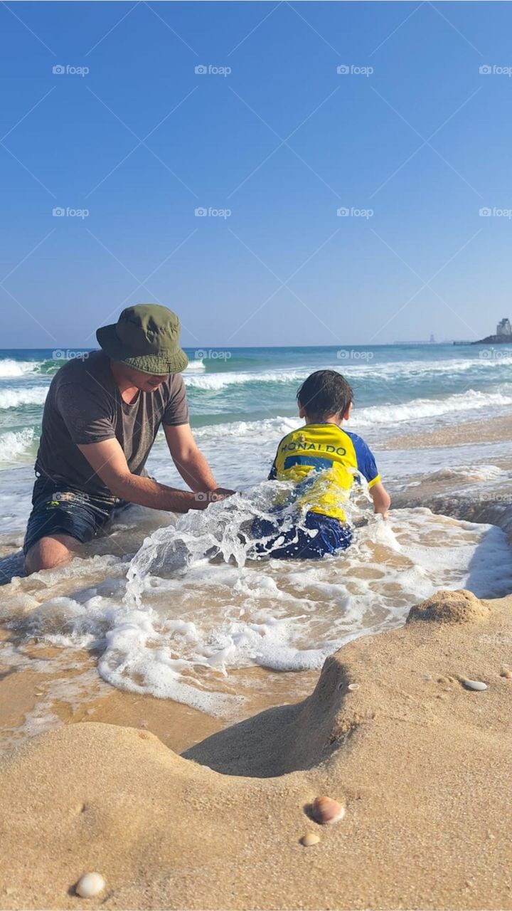 Playing with a child on the beach is fun