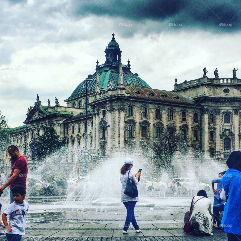 checking phone in Munich . girl checking her phone in the heart of Munich germany with a beautiful view