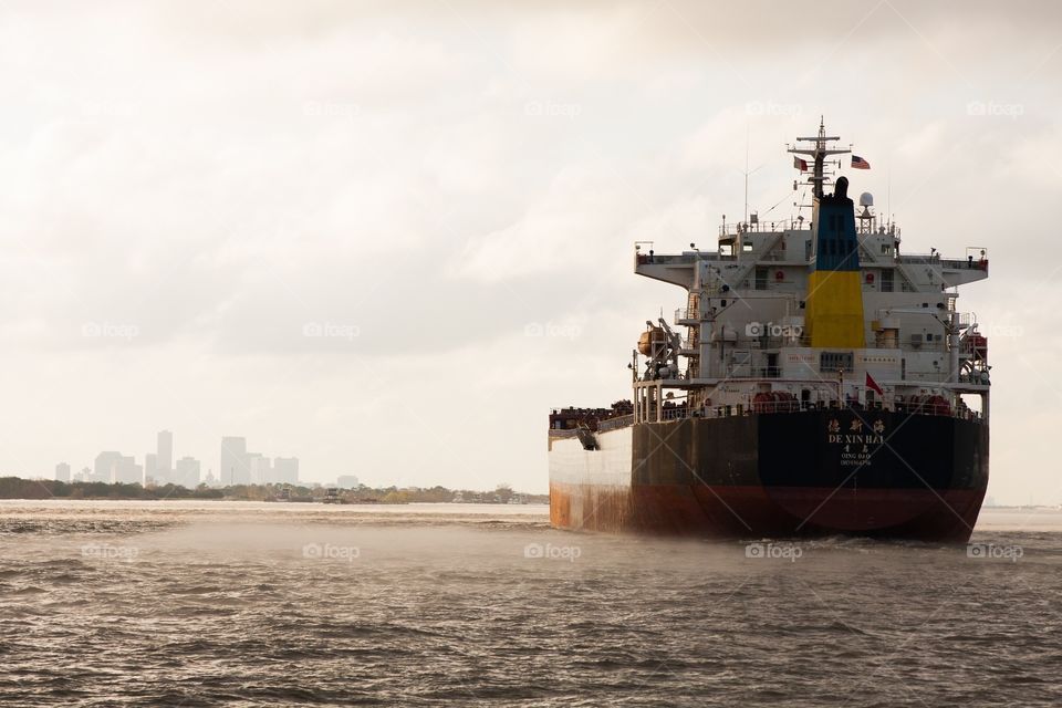 Import ship on Mississippi River with New Orleans in background 