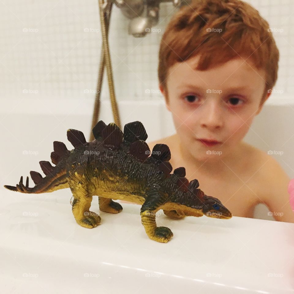 Having a bathtub with a dino. 
