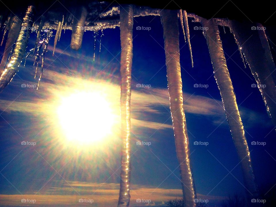 frosty day, the rays of the sun are scattered through the icicles