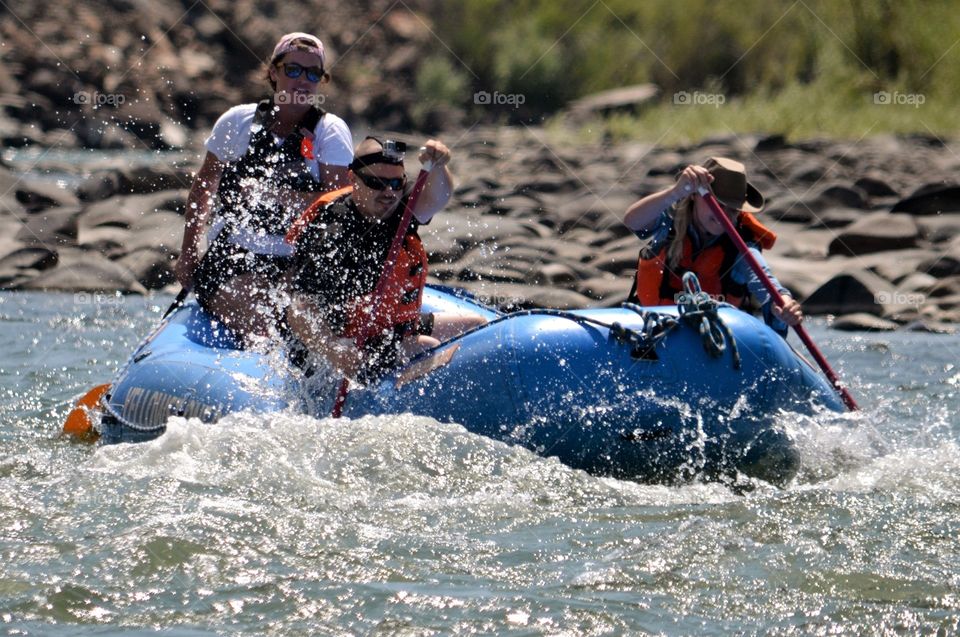 Group of people rafting on dinghy boat