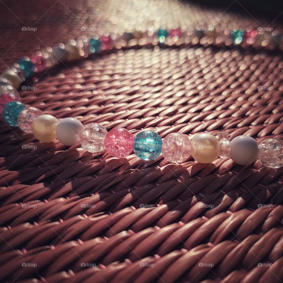 reflection of sunrays on beads and shadow