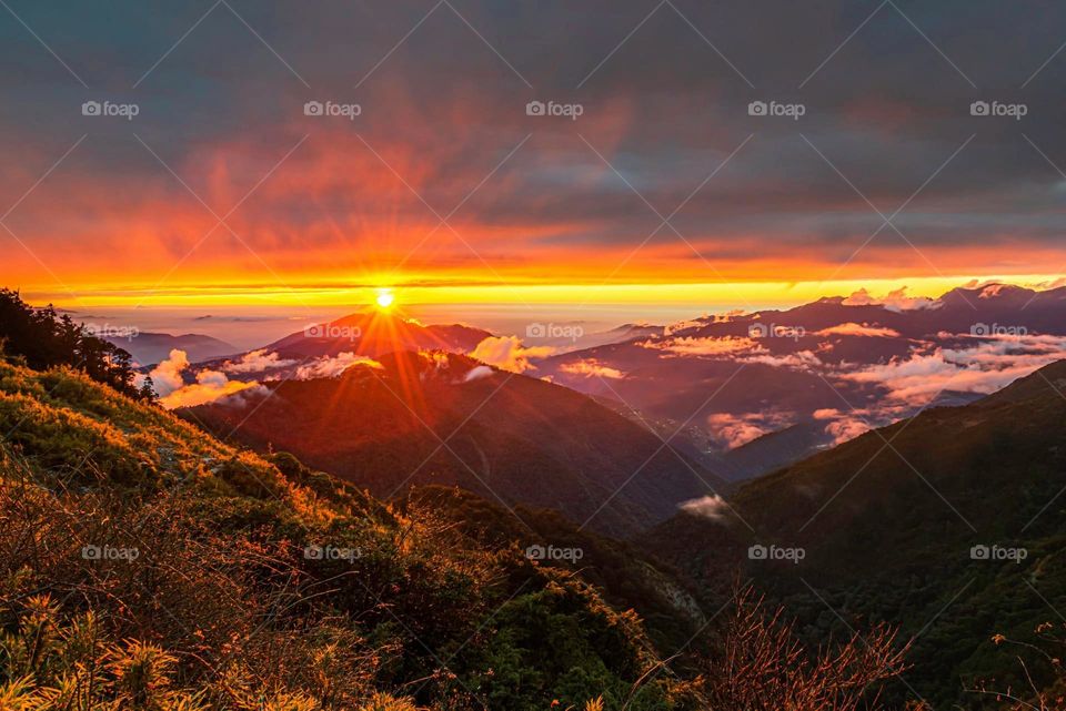Beautiful mountain scenery with sun set and sea of clouds