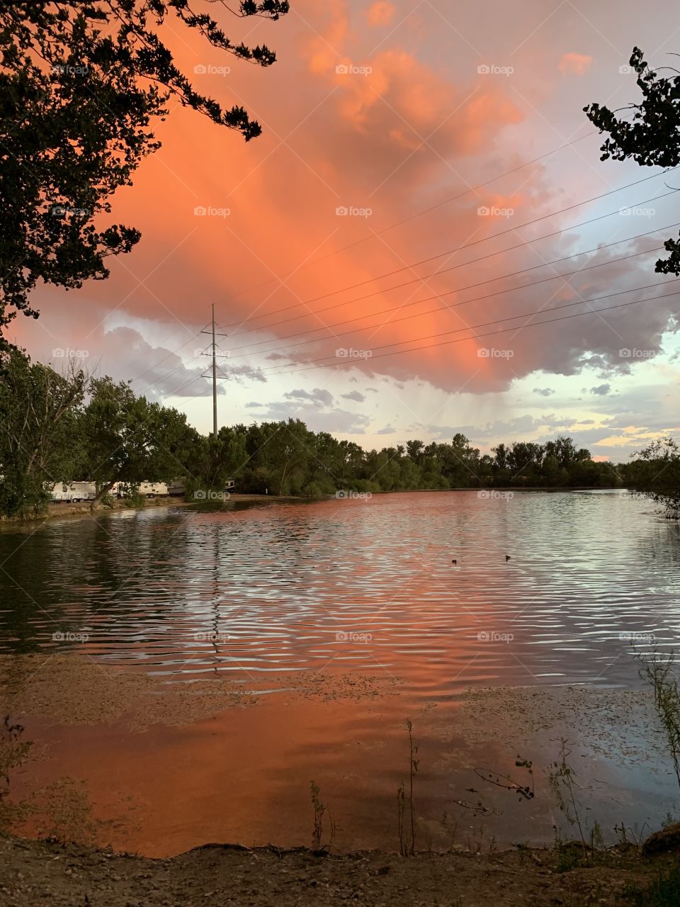 Storm sunset over pond 