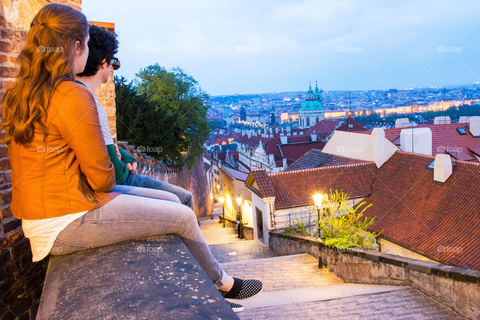 Two people sitting on wall at czech