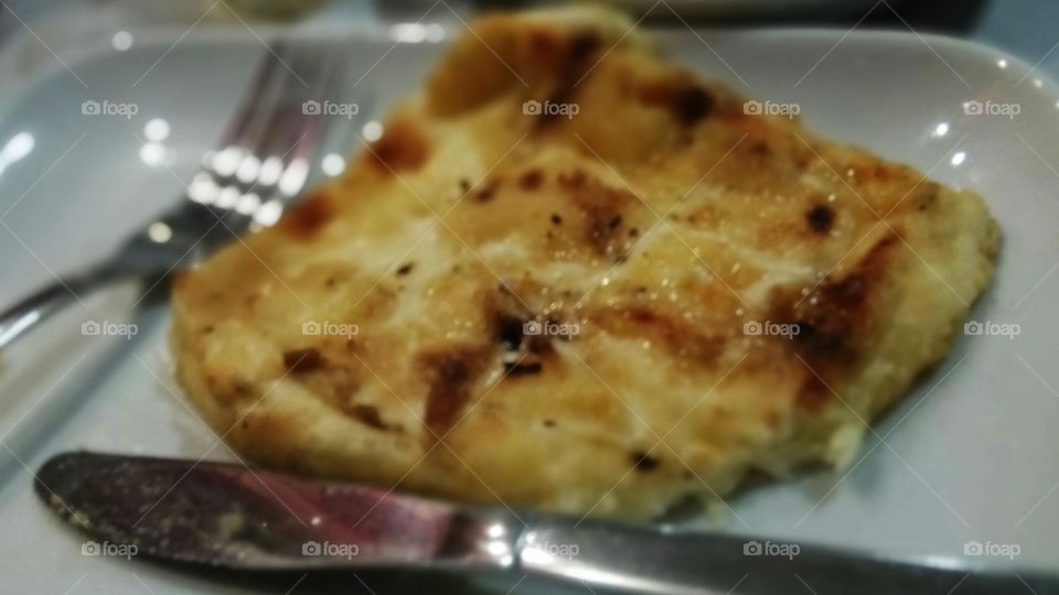 Eating delicious "saganaki" a traditional dish of fried cheese in Greece