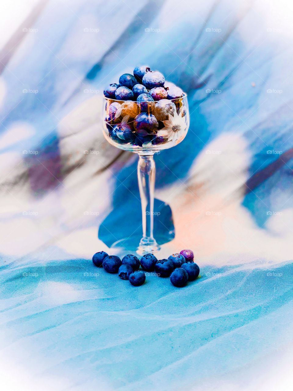 Ripe blueberries sitting in an antique crystal goblet. A lovely and appetizing sign of summer treats to come.