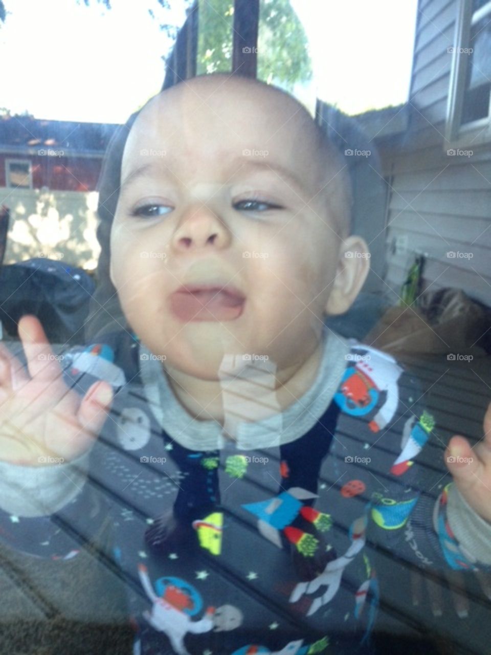 Baby licking the window.