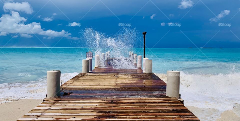 Splash of waves hitting the pier