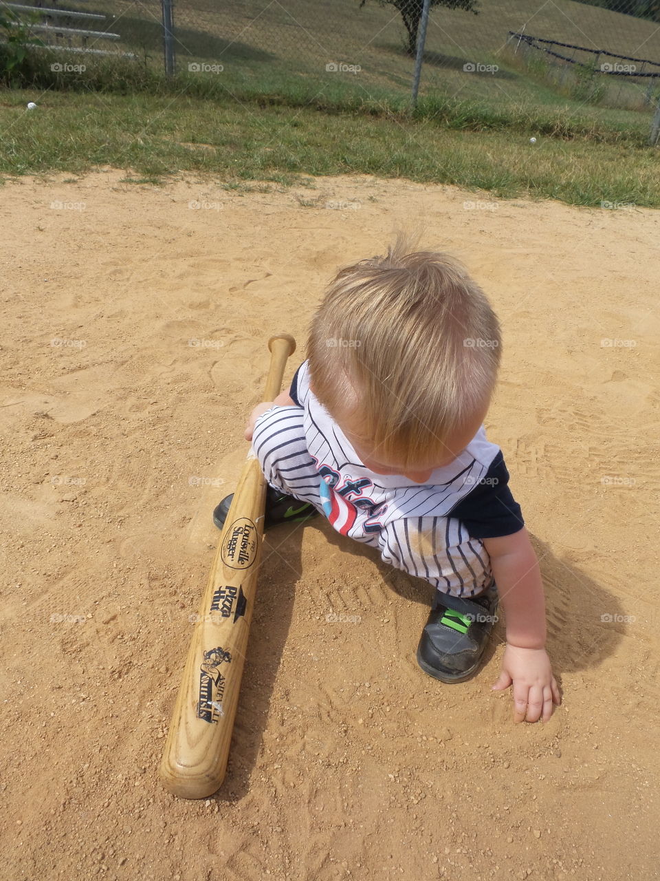 Baseball kid. playing in the dirt