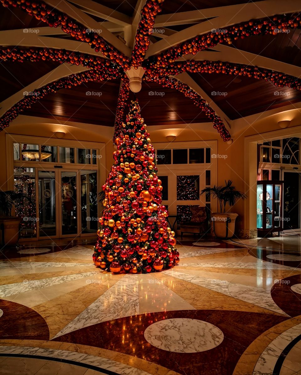 Fancy hotel foyer with lavishly decorated Christmas tree