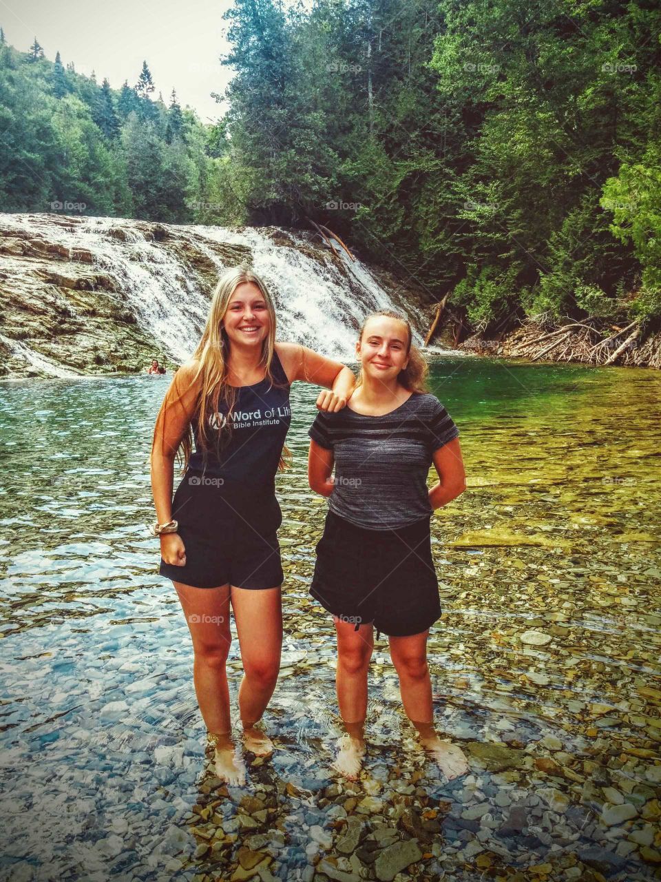 Two sisters enjoying a sunny afternoon by the river