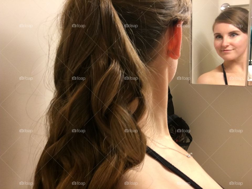 Young woman looking in mirror