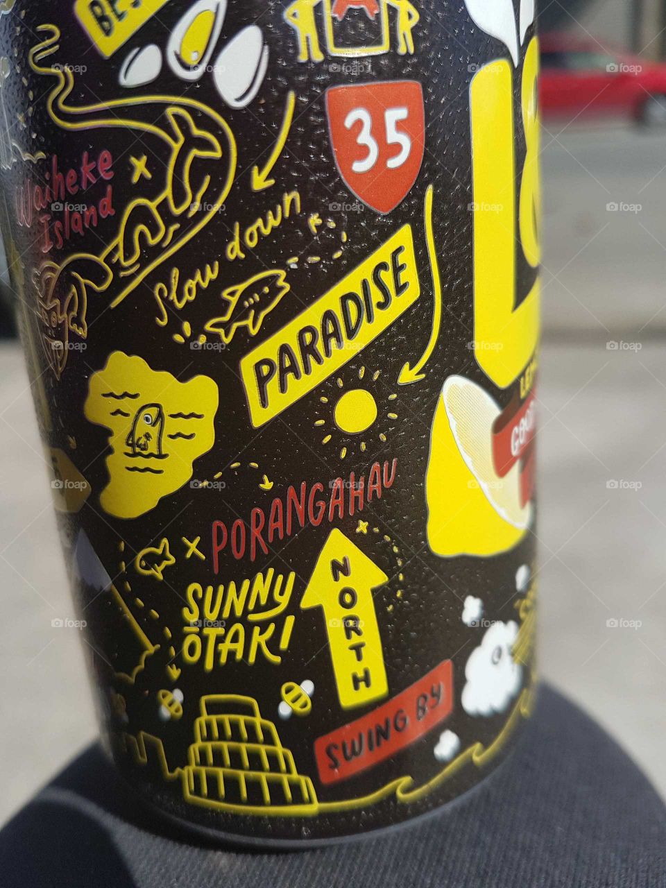 A Lemon drink can. Made in New Zealand words and pictures represent our country and some of our towns.