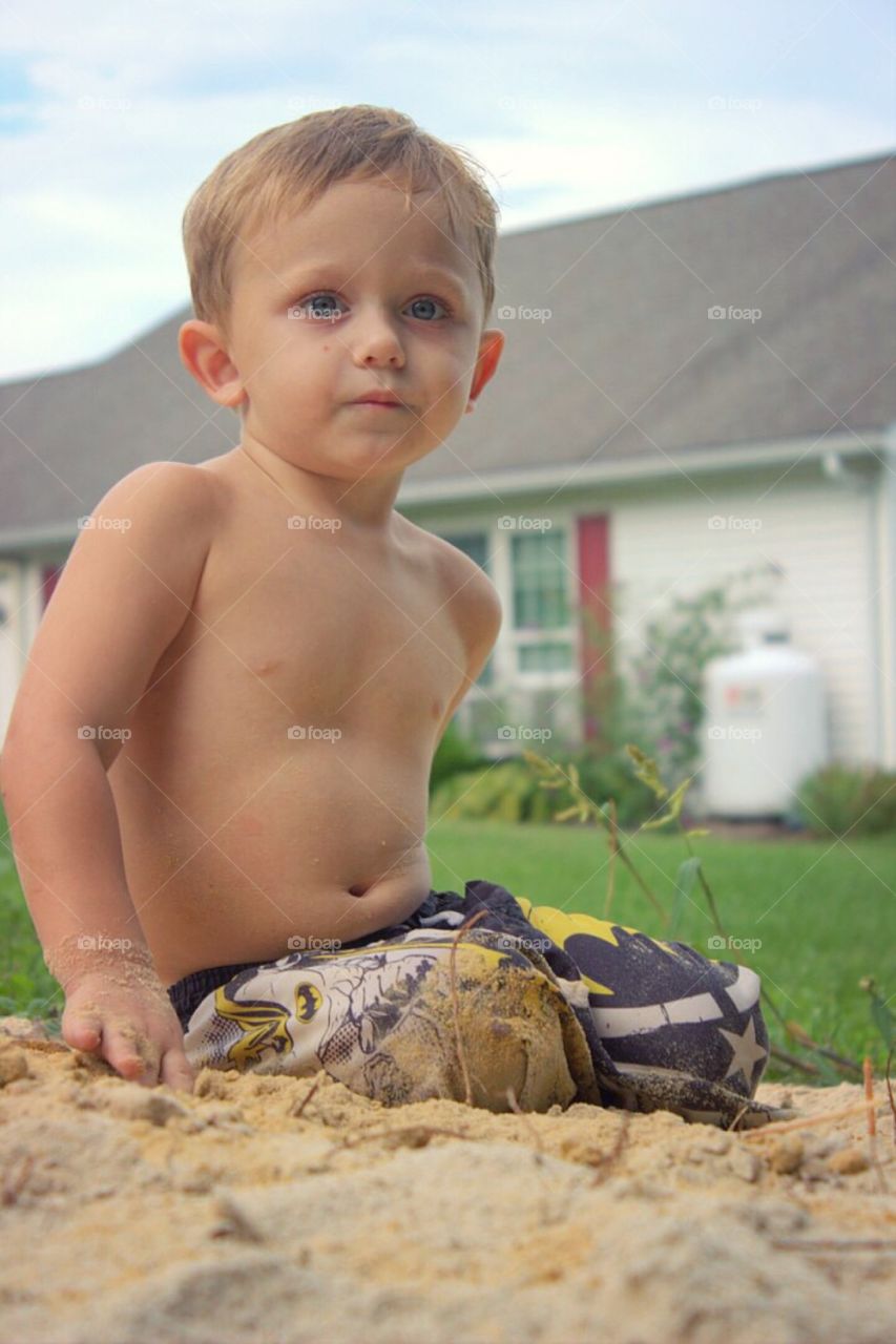 Portrait of a boy playing in sand