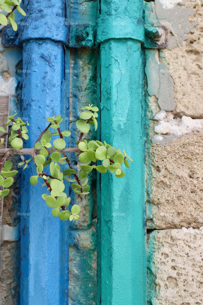 Coloured tubes on old wall