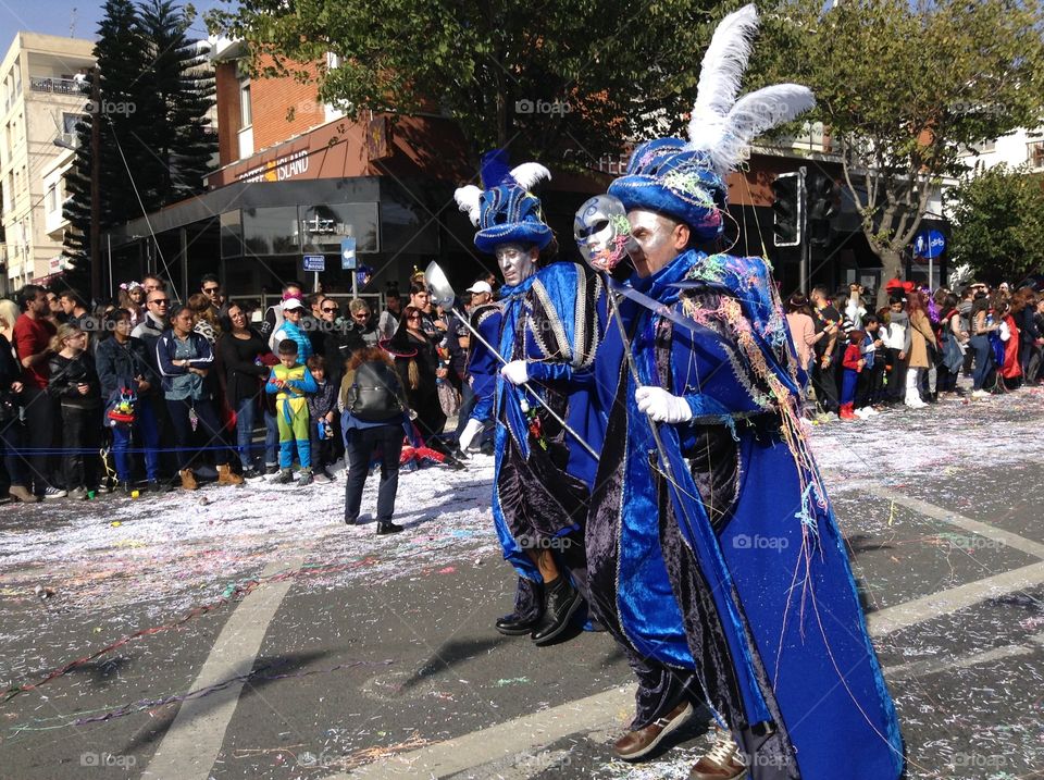Two men in costume walking in carnival parade.