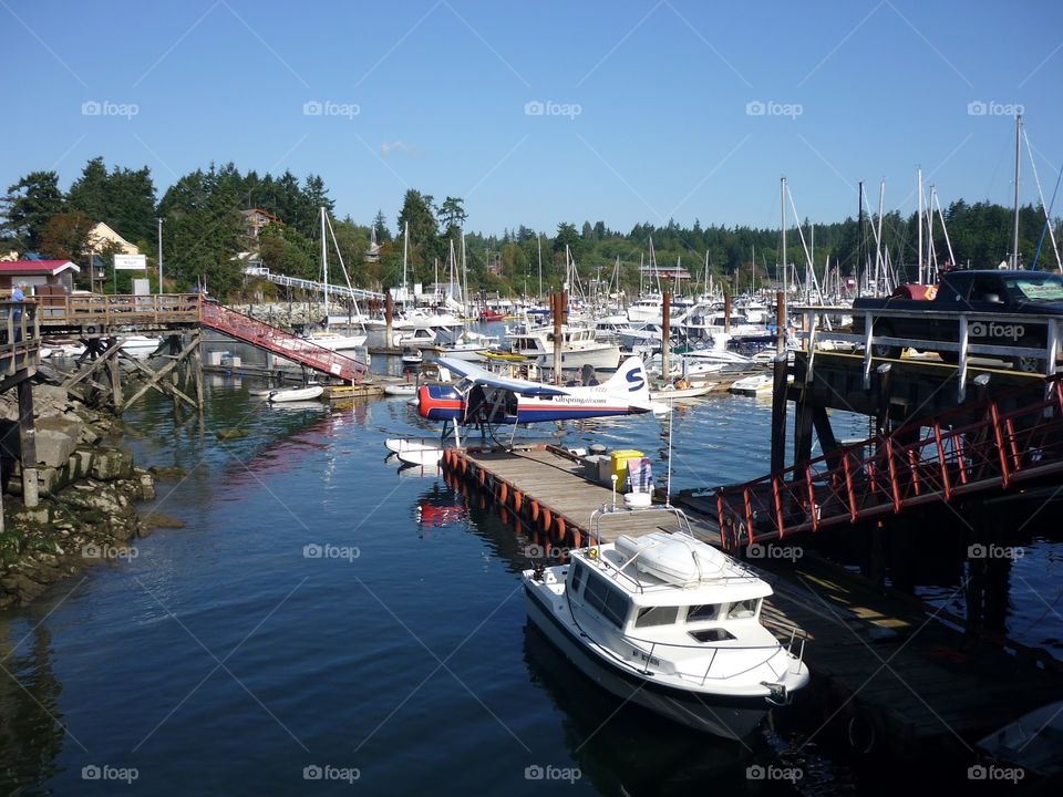 Ganges Village marina full of boats anchored for visitor’s stay on a calm and sunny day on Salt Spring Island in British Columbia 
