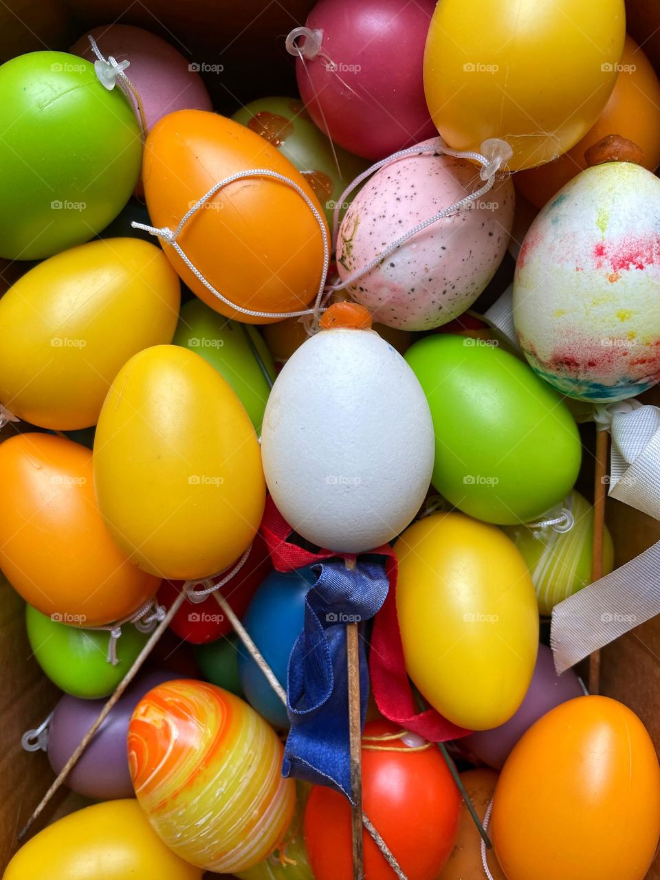 Close-up of many colorful Easter eggs in a box