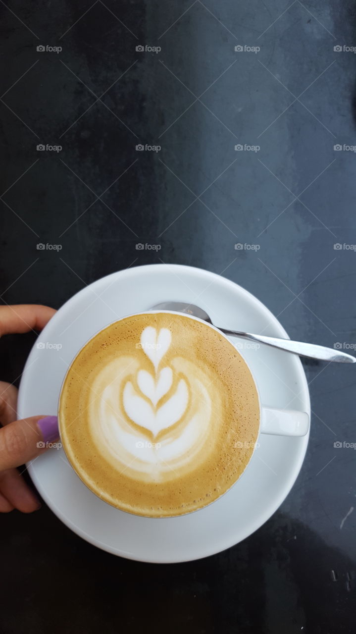 Close-up of a women's hand holding coffee