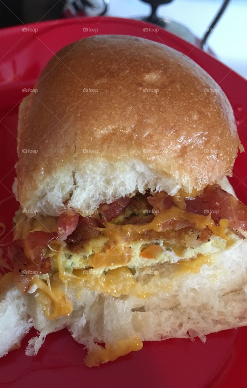 Breakfast sandwich slider. Omelette, bacon and cheese on crusty bread. 
