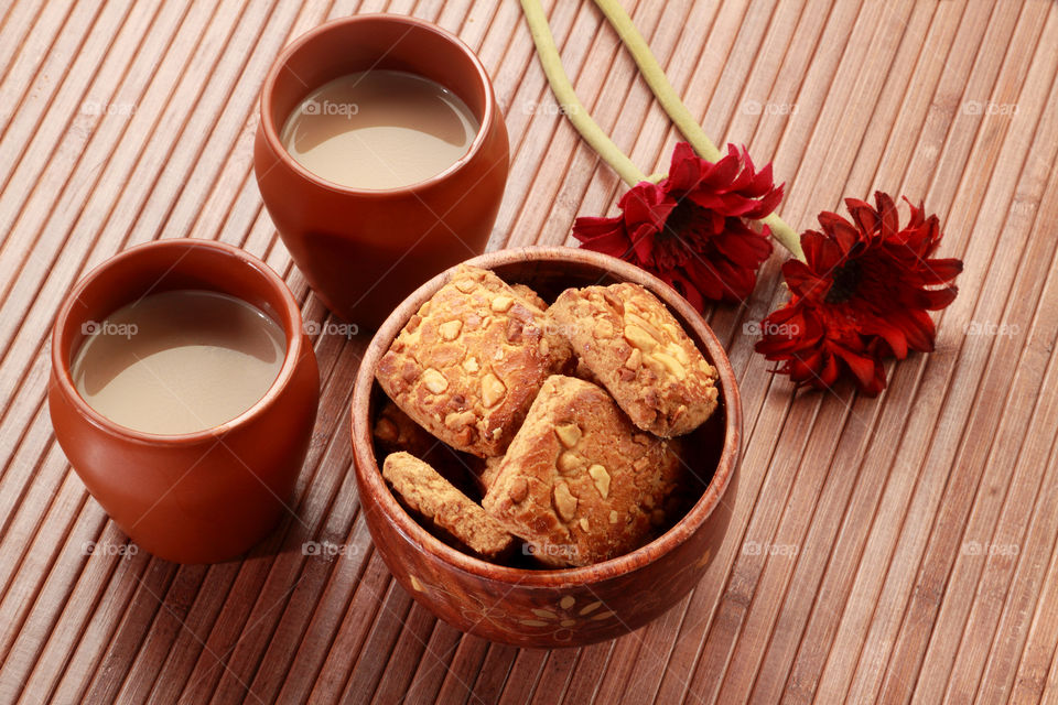 Indian handmade pottery glass and tea with handmade cookies