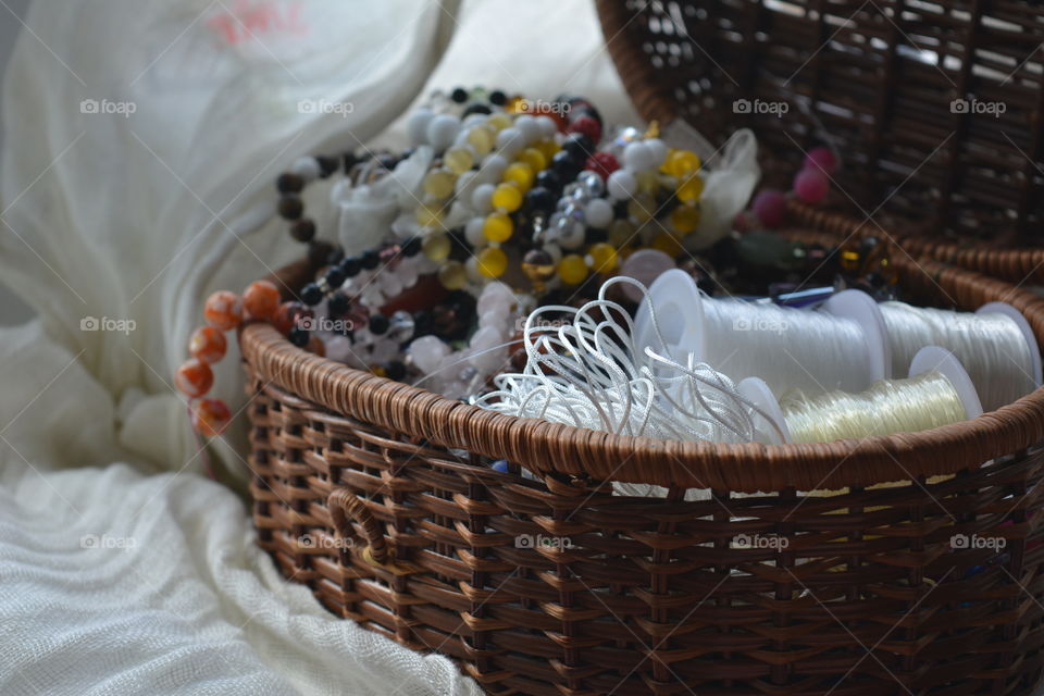 Necklaces and thread spool in basket