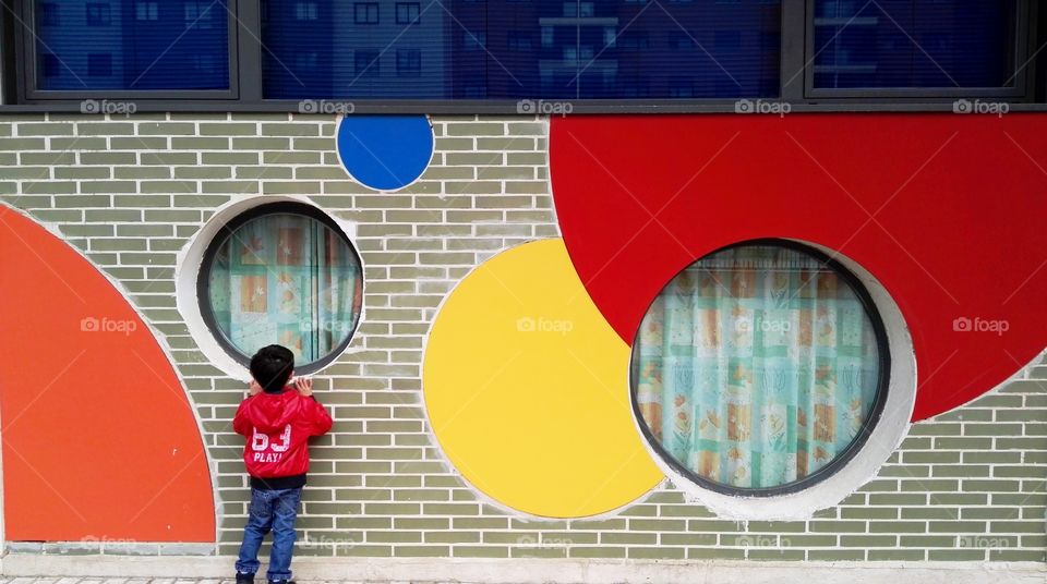 one boy looking through a window