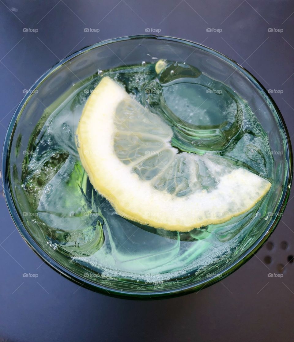 Cold sparkling water with ice and lemon 
