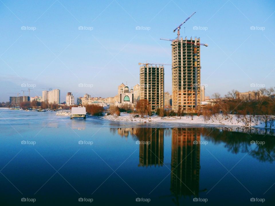 reflection in the water of unfinished buildings